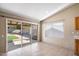 Dining area with tile floors, sliding doors leading to the backyard, and a large window for natural light at 1301 N Jackson St, Chandler, AZ 85225