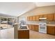 Bright, open kitchen with tile flooring, wood cabinetry, white appliances, and sliding glass doors to the backyard at 1301 N Jackson St, Chandler, AZ 85225