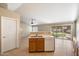 Open-concept kitchen includes a breakfast bar, white dishwasher, tile flooring, and a view of the adjacent living space at 1301 N Jackson St, Chandler, AZ 85225