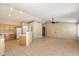 Bright open-concept living area with tile floors, neutral paint, a ceiling fan, and kitchen access for entertaining at 1301 N Jackson St, Chandler, AZ 85225