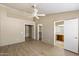 Large main bedroom features wood-look flooring, a ceiling fan, and access to an ensuite bathroom and closet at 1301 N Jackson St, Chandler, AZ 85225