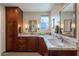 Elegant bathroom featuring granite countertops, dual sinks, and well-crafted wooden cabinetry at 1335 E Oregon Ave, Phoenix, AZ 85014