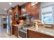 Kitchen featuring stainless steel appliances, granite countertops, and stylish backsplash at 1335 E Oregon Ave, Phoenix, AZ 85014