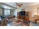 Cozy living room features comfortable seating, a ceiling fan, and natural light from a large window at 1335 E Oregon Ave, Phoenix, AZ 85014