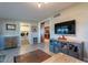 Interior living room showcasing ample space, large TV, and a view into the laundry room at 1335 E Oregon Ave, Phoenix, AZ 85014