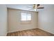 Bedroom features wood-look flooring, a window and a ceiling fan at 1340 N Oregon St, Chandler, AZ 85225