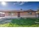 Exterior view of a house with a covered carport, desert landscaping, and a secure front door at 1340 N Oregon St, Chandler, AZ 85225