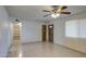 Living room with tile flooring, ceiling fan, and neutral paint, bathed in natural light at 1340 N Oregon St, Chandler, AZ 85225