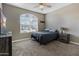 Cozy bedroom featuring a bed, ceiling fan, and arched window at 13624 W Desert Moon Way, Peoria, AZ 85383