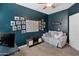 Inviting bedroom with a world map, sofa, and natural light at 13624 W Desert Moon Way, Peoria, AZ 85383