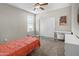 Comfortable bedroom with carpet, closet, a window, and a ceiling fan at 13624 W Desert Moon Way, Peoria, AZ 85383