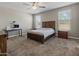 Bedroom featuring carpet, ceiling fan and natural light from two windows at 13624 W Desert Moon Way, Peoria, AZ 85383