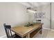 Bright dining area featuring a wooden table, bench, and modern light fixture, perfect for Gathering meals at 13624 W Desert Moon Way, Peoria, AZ 85383