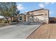 Charming single-story home with a two-car garage, neutral stucco, and terracotta roof tiles at 13624 W Desert Moon Way, Peoria, AZ 85383