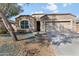 Charming single-story home with a two-car garage, neutral stucco, and terracotta roof tiles at 13624 W Desert Moon Way, Peoria, AZ 85383