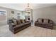 Living room featuring neutral walls, tile flooring, contemporary light fixture and comfortable seating at 13624 W Desert Moon Way, Peoria, AZ 85383