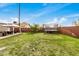 Lush backyard featuring a trampoline, patio area, and privacy fence, perfect for outdoor fun at 14008 N 61St Ave, Glendale, AZ 85306