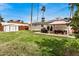 Expansive backyard with a grassy lawn, outdoor dining area, and privacy fence at 14008 N 61St Ave, Glendale, AZ 85306