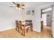 Cozy dining room featuring a wooden table, chairs, ceiling fan, and charming decor at 14008 N 61St Ave, Glendale, AZ 85306