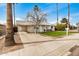 Inviting single-story home with covered carport, mature trees, and pleasant frontage at 14008 N 61St Ave, Glendale, AZ 85306