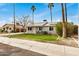 Well-kept home featuring solar panels, outdoor seating, and an inviting front yard at 14008 N 61St Ave, Glendale, AZ 85306