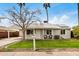 Charming home featuring a well-maintained lawn and covered carport at 14008 N 61St Ave, Glendale, AZ 85306