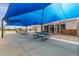 Outdoor patio with blue picnic tables and coverings at 14008 N 61St Ave, Glendale, AZ 85306