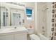 Bright bathroom featuring a shower-over-tub, vanity, and a clear view of a secondary room at 14432 W Yukon Dr, Sun City West, AZ 85375