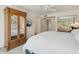 Bright bedroom featuring a wardrobe and view to another bedroom with desert landscaping at 14432 W Yukon Dr, Sun City West, AZ 85375