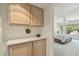 Bedroom with a large window, beige cabinets, and a view of the outside landscape at 14432 W Yukon Dr, Sun City West, AZ 85375