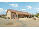 A home's exterior featuring a red tile roof, stucco walls, and a cozy patio area for outdoor enjoyment at 14432 W Yukon Dr, Sun City West, AZ 85375