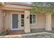 Inviting front entrance with decorative pillars and a charming security screen door at 14432 W Yukon Dr, Sun City West, AZ 85375