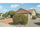 This single-story home features an attached garage, desert landscaping, and a tile roof at 14432 W Yukon Dr, Sun City West, AZ 85375