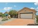 Single-story home featuring an attached garage, neutral paint, and mature landscaping at 14432 W Yukon Dr, Sun City West, AZ 85375