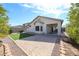 Beautiful backyard boasting a brick patio, low-maintenance landscaping, and ample space for outdoor entertaining at 14616 W Ventura St, Surprise, AZ 85379