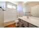 Bright bathroom featuring a vanity with drawers, bathtub with shower, and decorative mirror at 14616 W Ventura St, Surprise, AZ 85379