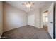 Neutral bedroom with carpet flooring, ceiling fan and closet, offering a comfortable and functional living space at 14616 W Ventura St, Surprise, AZ 85379