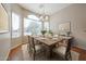 Bright dining room featuring a wooden table set, large window, and elegant chandelier at 14616 W Ventura St, Surprise, AZ 85379