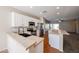 Bright kitchen with stainless steel appliances, white cabinetry, and an island with seating at 14616 W Ventura St, Surprise, AZ 85379