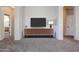 Neutral-toned living room featuring a modern media console and seamless transitions to adjacent spaces at 14616 W Ventura St, Surprise, AZ 85379