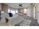 Serene main bedroom with a large bed, bay windows, and an ensuite bathroom entrance at 14616 W Ventura St, Surprise, AZ 85379