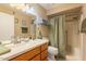 Well-lit bathroom featuring double sinks, a shower over tub, and classic fixtures at 14910 N Kings Way # 101, Fountain Hills, AZ 85268