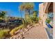 Charming outdoor patio space with desert landscaping featuring natural rocks, shrubs, and tall cactus at 14910 N Kings Way # 101, Fountain Hills, AZ 85268