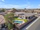 Aerial view of a property with a well-maintained backyard, sparkling pool, and an outdoor seating area at 151 N 116Th Dr, Avondale, AZ 85323