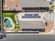 Top-down aerial view of a home with solar panels and a backyard pool and hammock setup at 151 N 116Th Dr, Avondale, AZ 85323