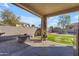 Covered patio providing a view of a backyard oasis, perfect for outdoor entertaining and relaxation at 151 N 116Th Dr, Avondale, AZ 85323