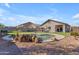 Resort-style backyard oasis with a sparkling pool, rock accents, and lush landscaping at 151 N 116Th Dr, Avondale, AZ 85323