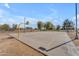 Outdoor basketball court with basketball hoops at each end and mature shade trees at 151 N 116Th Dr, Avondale, AZ 85323