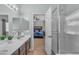 This bathroom features double sinks, modern vanity, and entry to the main bedroom at 151 N 116Th Dr, Avondale, AZ 85323