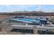 Aerial view of community pool with slides, seating, and parking featuring solar panel coverings at 151 N 116Th Dr, Avondale, AZ 85323